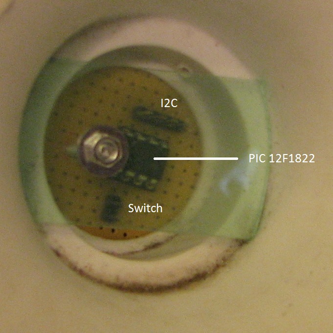 Top disc, perfboard with PIC12F1822 and connectors seen from below